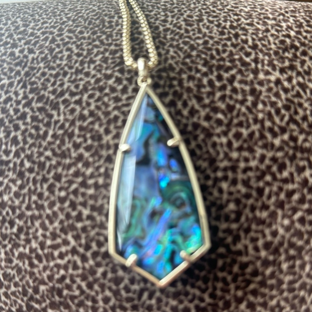 Kendra Scott gold chain with beautiful pendant blue, green, and black colors.